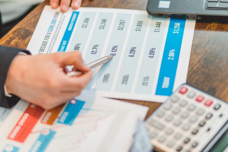 Person pointing at a paper of different rates